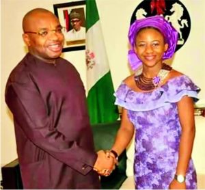 Governor Udom Emmanuel in a handshake with Christiana Esio Udoh